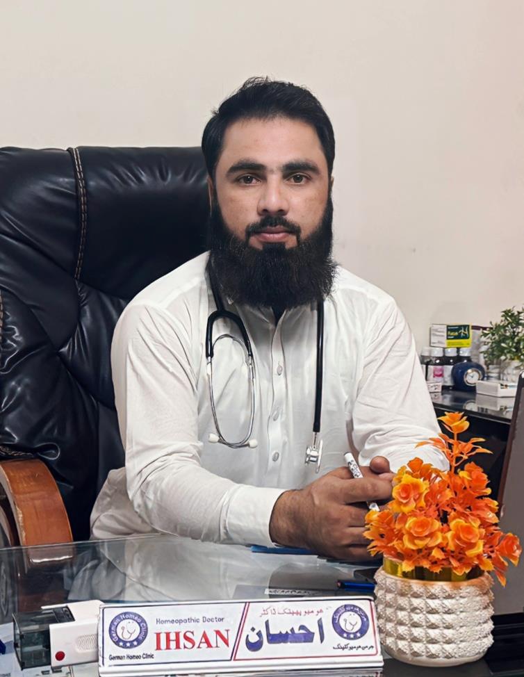 Doctor Ihsan Ullah seated at his desk in German Homeopathic Clinic